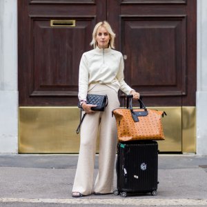 MILAN, ITALY - SEPTEMBER 22: Lisa Hahnbeuck (@lisarvd) wearing an Athleisure Look, Reebock sweater, Knit Pants Molli, bag Rimowa and MCM Nomad Travel Bag, Adiletten, Chanel Boy Bag outside Fendi during Milan Fashion Week Spring/Summer 2017 on September 22, 2016 in Milan, Italy. (Photo by Christian Vierig/Getty Images)