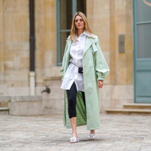 PARIS, FRANCE - MARCH 04: Natalia Verza @mascarada.paris wears sunglasses, a pale pastel mint green long trench coat from Max Mara, a white long shirt, a mini Chanel belt bag, black leggings, white sandals Bling Bling Alzuarr, on March 04, 2021 in Paris, France. (Photo by Edward Berthelot/Getty Images)