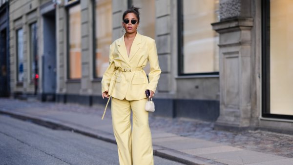 COPENHAGEN, DENMARK - FEBRUARY 01: Ellie Delphine wears sunglasses , a pastel pale yellow oversized blazer jacket , a belt, flared pants , outside Mark Kenly Domino Tan, during the Copenhagen Fashion Week AW24 on February 01, 2024 in Copenhagen, Denmark. (Photo by Edward Berthelot/Getty Images)