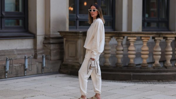 HAMBURG, GERMANY - AUGUST 16: Elise Seitz seen wearing white sunglasses from Celine, a creme white SohoStudios sweater, a creme white SohoStudios jogger pants, creme white linen Jacquemus Chiquito bag and beige suede Birkenstock Arizona sandals, on August 16, 2022 in Hamburg, Germany. (Photo by Jeremy Moeller/Getty Images)