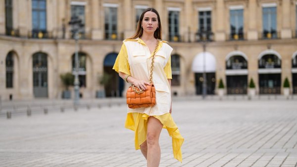 PARIS, FRANCE - MAY 07: Maria Rosaria Rizzo @lacoquetteitalienne wears a pale pastel yellow and beige shirt / flowing dress from Victoria/Tomas, a brown leather Bottega Veneta bag, sneakers from Nike Air Jordan with orange printed houndstooth patterns, on May 07, 2021 in Paris, France. (Photo by Edward Berthelot/Getty Images)