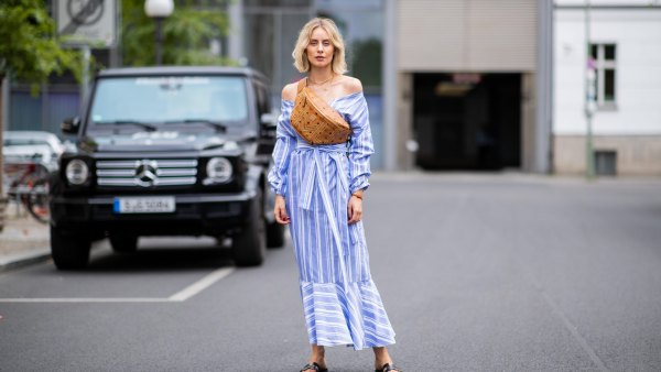 BERLIN, GERMANY - JULY 06: Lisa Hahnbueck wearing striped off shoulder dress Mykke Hofmann, MCM Stark fanny belt bag, Hermes Oran sandals seen during the Berlin Fashion Week July 2018 on July 6, 2018 in Berlin, Germany. (Photo by Christian Vierig/Getty Images)