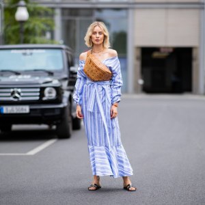 BERLIN, GERMANY - JULY 06: Lisa Hahnbueck wearing striped off shoulder dress Mykke Hofmann, MCM Stark fanny belt bag, Hermes Oran sandals seen during the Berlin Fashion Week July 2018 on July 6, 2018 in Berlin, Germany. (Photo by Christian Vierig/Getty Images)