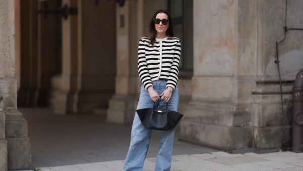 HAMBURG, GERMANY - MAY 09: Elise Seitz seen wearing Bottega Veneta black shades, Celine black belt, Adidas black samba sneaker, Agolde blue jeans, Massimo Dutti striped black and white cardigan and Demellier black bag on May 09, 2023 in Hamburg, Germany. (Photo by Jeremy Moeller/Getty Images)