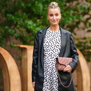 PARIS, FRANCE - SEPTEMBER 24: Noor de Groot wears large earrings, a black leather jacket, a white dress with printed polka dots, a Dior monogram logo bag wears, outside Dior, during Paris Fashion Week - Womenswear Spring Summer 2020, on September 24, 2019 in Paris, France. (Photo by Edward Berthelot/Getty Images)