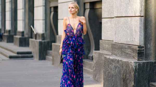 MILAN, ITALY - FEBRUARY 22: Leonie Hanne wears a blue ruffled dress with pink floral print, a black Jacquemus mini bag, outside Philosophy, during Milan Fashion Week Fall/Winter 2020-2021 on February 22, 2020 in Milan, Italy. (Photo by Edward Berthelot/Getty Images)