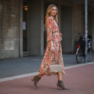 DUSSELDORF, GERMANY - MARCH 24: Scarlett Gartmann wearing Mango flower dress, beige Chanel Boy bag and brown Kennel & Schmenger leather boots on March 24, 2021 in Dusseldorf, Germany. (Photo by Jeremy Moeller/Getty Images)