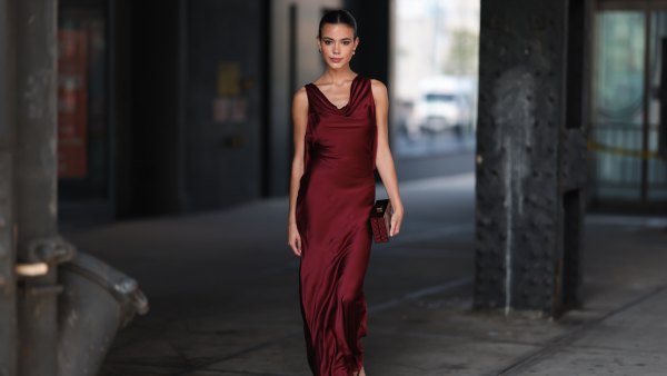 NEW YORK - SEPTEMBER 08: Ella Grace Mendelsohn is seen wearing golden earrings, a backless sleeveless wine-red satin maxi dress, a clutch from Kate Spade with red rhinestones and black strap heels outside before Kate Spade presentation on September 08, 2023 in New York City. (Photo by Jeremy Moeller/Getty Images)