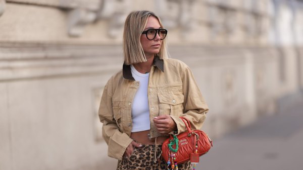 VIENNA, AUSTRIA - AUGUST 26: Karin Teigl seen wearing Andy Wolf black sunglasses, By Aylin Koenig white cotton basic cropped shirt, Bershka brown animal printed oversized long pants, Zara beige cropped cord jacket, Miu Miu orange leather Arcadie bag with colorful bag charms, on August 26, 2024 in Vienna, Austria. (Photo by Jeremy Moeller/Getty Images)