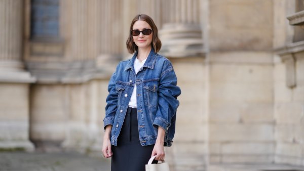 PARIS, FRANCE - MAY 25: Marissa Cox wears an Arket black skirt, an Arket white t-shirt, a blue oversize Agolde denim jacket, a white Arket leather bag, Jimmy Fairly x Reformation sunglasses, and Alighieri necklace, during a street style fashion photo session, on May 25, 2024 in Paris, France. (Photo by Edward Berthelot/Getty Images)