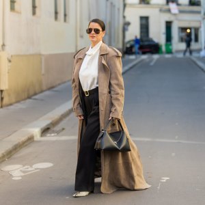 PARIS, FRANCE - SEPTEMBER 29: Gili Biegun wears extra long beige suede coat, snake leather boots, black leather Toteme T lock bag, black trousers and white Silk Turtle neck blouseduring the Womenswear Spring Summer 2026 as part of Paris Fashion Week on September 29, 2025 in Paris, France. (Photo by Christian Vierig/Getty Images)