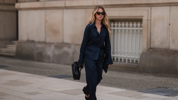 HAMBURG, GERMANY - JUNE 09: Liesa Späht seen wearing black sunglasses from Celine, a dark blue silk blouse from SoSue, a matching dark blue silk wide leg pants from SoSue, black heels from Saint Laurent and a black leather Khaite bag on June 09, 2022 in Hamburg, Germany. (Photo by Jeremy Moeller/Getty Images)