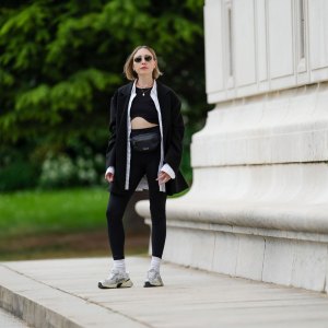 PARIS, FRANCE - MAY 12: Emy Venturini wears sunglasses from Ray Ban, a necklace, a white shirt from Louis Vuitton, a black Zara crop top, a black oversize blazer jacket from The Frankie Shop, black leggings from Intimissimi, white socks from Calzedonia, Nike sneakers shoes, a black leather belt bag / fanny pack from Patagonia, during a street style fashion photo session, on May 12, 2024 in Paris, France. (Photo by Edward Berthelot/Getty Images)