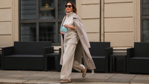 Elise Soho wearing Birkenstock beige sandals, Joseph beige two piece, Nanushka beige coat, Loewe mini blue baby bag on August 30, 2021 in Hamburg, Germany.