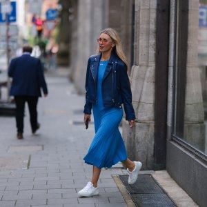 DUSSELDORF, GERMANY - JUNE 13: Scarlett Gartmann-Reus seen wearing a red sunglasses, a blue midi dress from Off White, a blue leather jacket from Iro Paris and white leather sneakers from Copenhagen Studios on June 13, 2022 in Dusseldorf, Germany. (Photo by Jeremy Moeller/Getty Images)