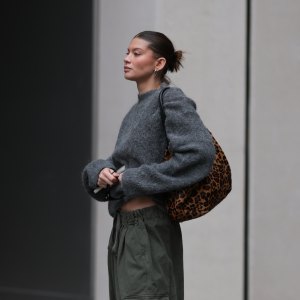 BERLIN, GERMANY - OCTOBER 17: Sophia Geiss with a brown haired sleek bun seen wearing a grey oversized LeGer sweater styled with khaki Frankie Shop cargo wide pants, black LeGer boots, and Mango rectangular sunglasses, carrying a leopard-print DeMellier Leo bag on October 17, 2025 in Berlin, Germany. (Photo by Jeremy Moeller/Getty Images)