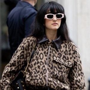MILAN, ITALY - SEPTEMBER 27: A guest wears brown trousers, beige sunglasses, a leopard printed cargo cropped jacket, a brown silk skirt and a black leather bag outside Dolce & Gabbana show during the Milan Fashion Week Womenswear Spring/Summer 2026 on September 27, 2025 in Milan, Italy. (Photo by Valentina Frugiuele/Getty Images)