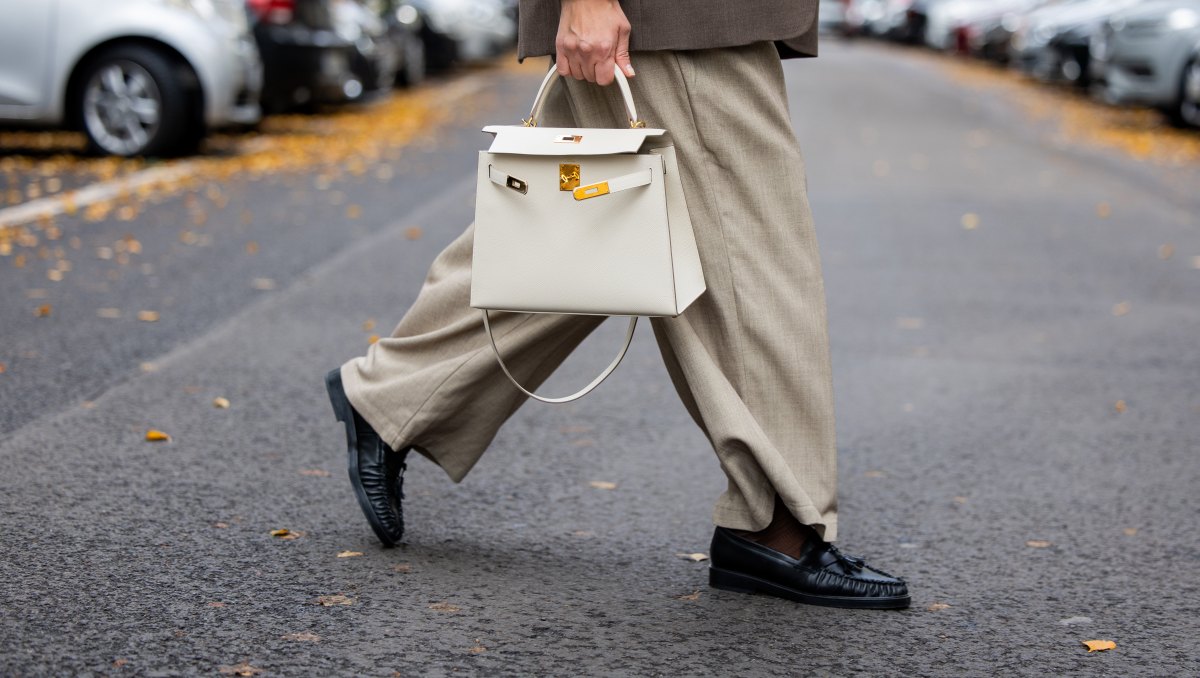 BERLIN, GERMANY - OCTOBER 09: Victoria Scheu wears beige wide leg pants H&M, collarless gray blazer COS, Hermes kelly bag Craie, scarf Zara, loafers on October 09, 2025 in Berlin, Germany. (Photo by Christian Vierig/Getty Images)