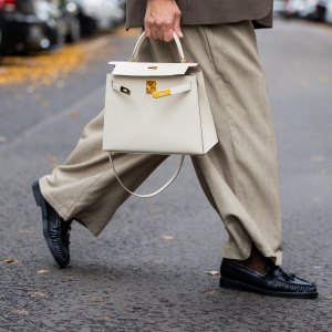BERLIN, GERMANY - OCTOBER 09: Victoria Scheu wears beige wide leg pants H&M, collarless gray blazer COS, Hermes kelly bag Craie, scarf Zara, loafers on October 09, 2025 in Berlin, Germany. (Photo by Christian Vierig/Getty Images)