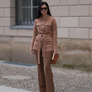 Leo Eberlin seen wearing YSL brown tortoise sunglasses, Leo Mathild diamond jewelry, Allude x Leo Mathild brown cashmere wool cardigan jacket, Zara brown suit pants, Fendi brown leather clutch / pouch bag and Christian Louboutin brown leather heels / pumps, on February 25, 2024 in Berlin, Germany.