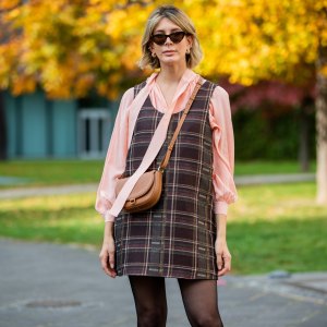 FRANKFURT AM MAIN, GERMANY - OCTOBER 26: Victoria Scheu is seen wearing mini checkered dress and salmon colored bow-tie blouse Nobi Talai, sheer tights, cat-eye sunglasses Mango, brown bag Carolina Herrera on October 26, 2020 in Frankfurt am Main, Germany. (Photo by Christian Vierig/Getty Images)