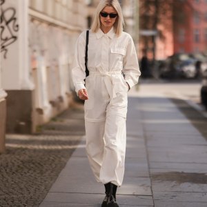 BERLIN, GERMANY - MARCH 28: Lena Gercke seen wearing a white denim overall from LeGer, a black sunglasses from Prada, silver earrings from LeGer, a black handbag from LeGer and black leather boots from LeGer on March 28, 2022 in Berlin, Germany. (Photo by Jeremy Moeller/Getty Images)