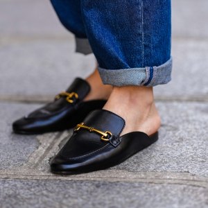 PARIS, FRANCE - APRIL 15: Diane Batoukina @diaanebt wears navy blue denim rolled-up large pants from Rouje, black shiny leather loafers mules from Massimo Dutti, during a street style fashion photo session, on April 15, 2022 in Paris, France. (Photo by Edward Berthelot/Getty Images)