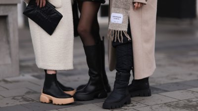 REYKJAVIK, ICELAND - NOVEMBER 15: Annabel Rosendahl (L) is seen wearing Copenhagen Studios CPH 276 Vitello black/ pale beige boots, Copenhagen Studios black clutch bag and Dorothee Schumacher creme white wool coat; Marie Hindkaer (M) is seen wearing a black Prada nylon bag, black leather Copenhagen Studios CPH145 boots, creme white Samsoe Samsoe knit sweater, Acne Studios black short skirt and a black Jw Anderson x Uniqlo jacket; Mie Juel (R) wears Copenhagen Studios beige wool scarf, Copenhagen Studios CPH149 black boots, Birgitte Herskind beige wool coat and black Basic Apparel pants, on November 15, 2022 in Reykjavik, Iceland. (Photo by Jeremy Moeller/Getty Images for Copenhagen Studios)