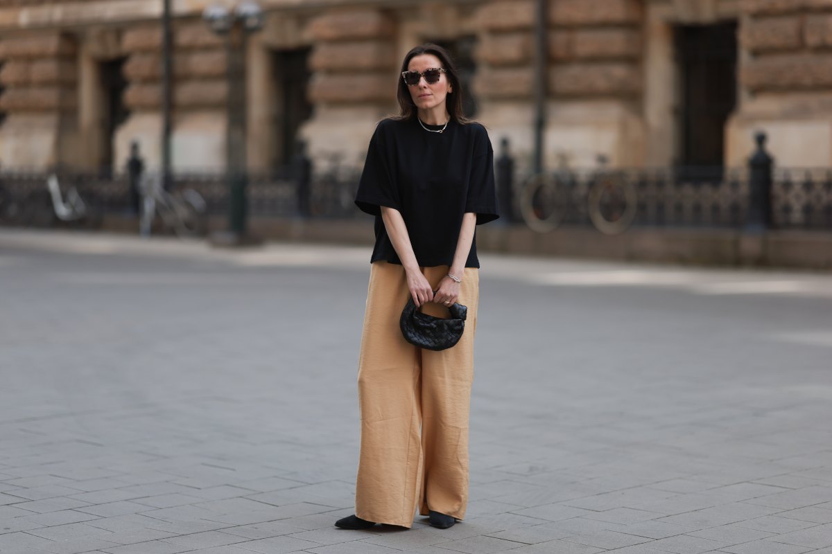 HAMBURG, GERMANY - MAY 09: Elise Seitz seen wearing a Bottega Veneta Jodie black leather bag, Isabel Marant black boots, Soho Studios black shirt and beige and brown pants and Ace and Tate black shades on May 09, 2023 in Hamburg, Germany. (Photo by Jeremy Moeller/Getty Images)