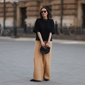 HAMBURG, GERMANY - MAY 09: Elise Seitz seen wearing a Bottega Veneta Jodie black leather bag, Isabel Marant black boots, Soho Studios black shirt and beige and brown pants and Ace and Tate black shades on May 09, 2023 in Hamburg, Germany. (Photo by Jeremy Moeller/Getty Images)