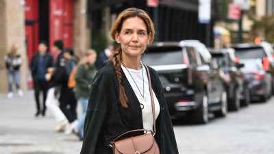 Katie Holmes spotted with her hair in a long braid and wearing a DeMellier bag on October 29, 2025 in New York City.