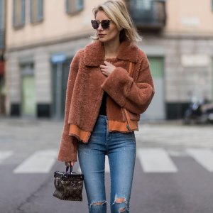 MILAN, ITALY - FEBRUARY 26: Lisa Hahnbueck wearing Designers Remix Candy Coat Boxy Shearling Coat with large collar and zipper, Citizens of Humanity jeans, OF HUMANITY JEANS, Louis Vuitton Star Trail ankle boot, Louis Vuitton Supple Rigid bag in Monogram canvas, Prada Sunglasses during Milan Fashion Week Fall/Winter 2017/18 on February 26, 2017 in Milan, Italy. (Photo by Christian Vierig/Getty Images)
