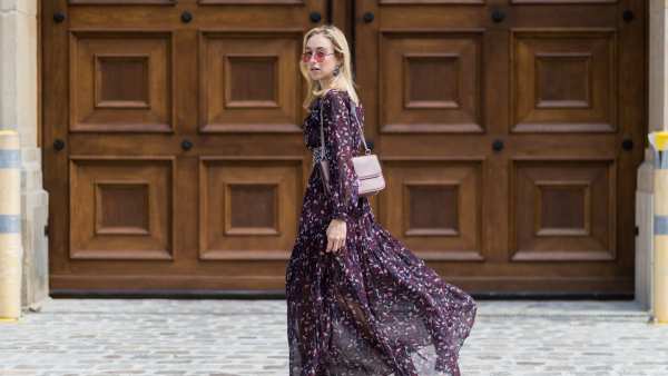 BERLIN, GERMANY - AUGUST 01: Sonia Lyson wearing a boho dress with long sleeves from Tara Jarmon, vintage belt, pink Valentino bag, olive green heeled boots Topshop, pink Vogue x Gigi Hadid sunglasses on August 1, 2017 in Berlin, Germany. (Photo by Christian Vierig/Getty Images)