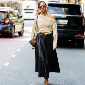 NEW YORK, NEW YORK - SEPTEMBER 13: Blanca Arimany wears beige asymmetric top, black leather skirt, brown suede bag, heels, sunglass outside Altuzarra during New York Fashion Week on September 13, 2025 in New York City. (Photo by Christian Vierig/Getty Images)