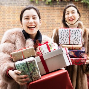 Woman shopping for holiday gifts online and bringing them to a party