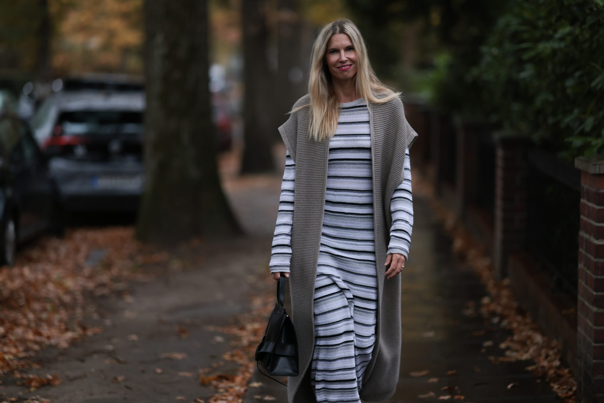 HAMBURG, GERMANY - NOVEMBER 17: Vanessa Giers seen wearing SoSUE Laura black and white knit dress ,SoSUE&nbsp;Knit Cosy Azteco beige vest, Naditum black leather handbag,&nbsp;& other stories black boots on November 17, 2022 in Hamburg, Germany. (Photo by Jeremy Moeller/Getty Images)