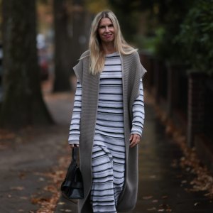 HAMBURG, GERMANY - NOVEMBER 17: Vanessa Giers seen wearing SoSUE Laura black and white knit dress ,SoSUE Knit Cosy Azteco beige vest, Naditum black leather handbag, & other stories black boots on November 17, 2022 in Hamburg, Germany. (Photo by Jeremy Moeller/Getty Images)