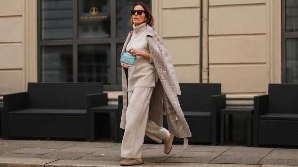 Elise Soho wearing Birkenstock beige sandals, Joseph beige two piece, Nanushka beige coat, Loewe mini blue baby bag on August 30, 2021 in Hamburg, Germany.