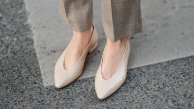 PARIS, FRANCE - MARCH 25: A close-up of beige pointed-toe leather pumps worn with taupe wool trousers, during a street style fashion photo session on March 25, 2025 in Paris, France. (Photo by Edward Berthelot/Getty Images)