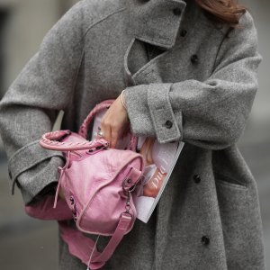 New Handbags MUNICH, GERMANY - JANUARY 8: Amanda Mühle is seen wearing a grey wool coat with wide lapels, button closure and buttoned collar from Siyazu; a pink leather Balenciaga “City bag” with a softly slouched shape, top handles and silver hardware from Balenciaga; multiple silver rings from Pilgrim; holding a Vogue Magazine on January 8, 2026 in Munich, Germany.