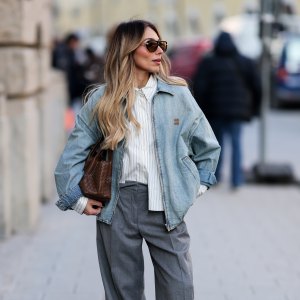 MUNICH, GERMANY - FEBRUARY 1: Oeznur Sinani alias Sinperi is wearing a light blue zip-up jacket by Miu Miu; a white shirt with blue stripes by Miu Miu; a wide-leg grey trousers by Windsor; New Balance X Miu Miu 530 SL mules in faded suede; black aviator sunglasses by Bottega Veneta; small silver hoop earrings by Cartier; a vintage tennis bracelet by Cartier; a gold Love bracelet by Cartier; gold and silver rings by Cartier; a wristwatch by Cartier; a light brown woven bag by Bottega Veneta; her blonde hair is styled in light waves on February 1, 2026 in Munich, Germany. (Photo by Moritz Scholz/Getty Images)