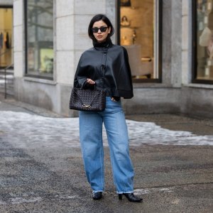 BERLIN, GERMANY - FEBRUARY 10: Bella Emar wears Gina Tricot black leather Cape, My essential wardrobe ripped jeans, flattered boots, black Bottega Veneta bag on February 10, 2026 in Berlin, Germany. (Photo by Christian Vierig/Getty Images)