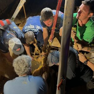 A photo shows the rescue of a man stuck in mud