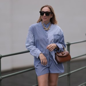 BERLIN, GERMANY - JUNE 28: Sonia Lyson wearing Gold Zara statement link chain, Storets matching two piece set includes a buttoned blue and white striped flannel and short, Linda Farrow brown big shades and Gucci bamboo brown leather wood bag on June 28, 2023 in Berlin, Germany. (Photo by Jeremy Moeller/Getty Images)