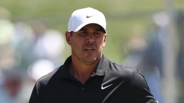 GettyImages-2267717697 Brooks Koepka consoles young girl trapped under golf cart
