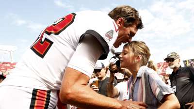 GettyImages-1427328428-Tom-Brady-Passes-Olympic-Torch-to-Daughter-Vivian-Lake-After-Ruling-Out-His-Own-Bid
