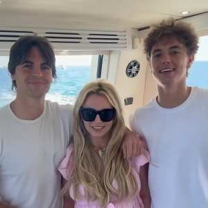 Sean Preston, Britney Spears and Jayden James smiling together on a boat.