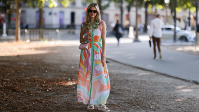 Anna Wolfers wearing colorful wrap dress via Goldig Shop, pink Moschino leather bag and brown heeled clogs on May 31, 2021 in Hamburg, Germany