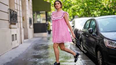 PARIS, FRANCE - MAY 05: Ketevan Giorgadze @katie.one wears a pink babydoll sleeveless mini dress with embroidery "broderie anglaise" from Manoush, a black leather pearl bag from LPA, classic masculine leather loafers shoes from Prada, pearl pony cuff from Lelet NY, on May 05, 2021 in Paris, France. (Photo by Edward Berthelot/Getty Images)