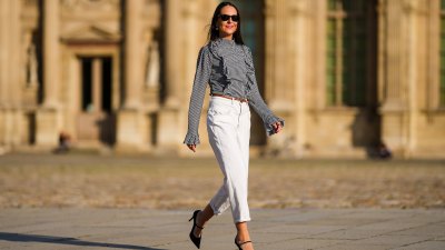 Alba Garavito Torre wears a gingham checkered black and white shirt with Long Sleeve Ruffles from Serendipia, Mom jeans in white from Maison 123 Paris, a brown leather thin belt, Black Mary Jane high heels shoes from Gucci, on October 10, 2021 in Paris, France.